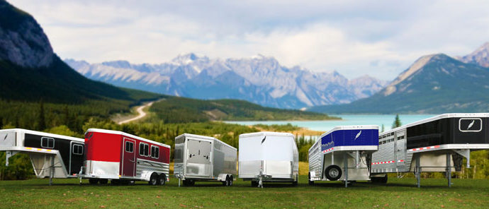 Featherlite lineup of various horse trailers in front of mountain range