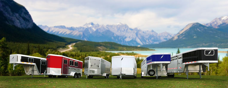 Featherlite lineup of various horse trailers in front of mountain range