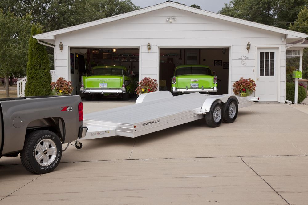 Featherlite open utility trailer in front of garage