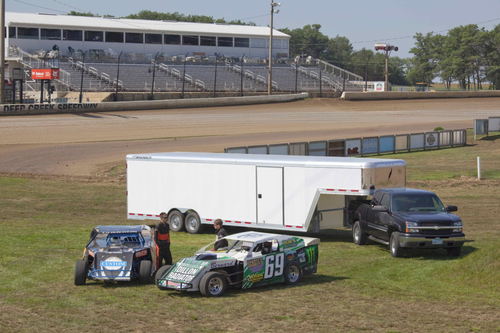 Pickup truck hauling an enclosed car trailer on racing infield